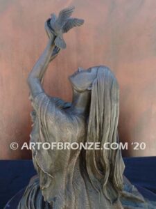 Spirit of the Sky bronze statue of seated Native American Indian woman holding bird