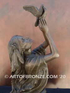 Spirit of the Sky bronze statue of seated Native American Indian woman holding bird