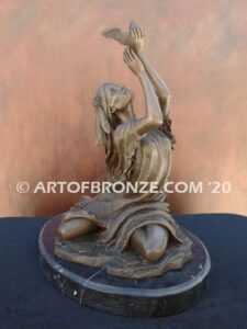 Spirit of the Sky bronze statue of seated Native American Indian woman holding bird