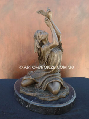 Spirit of the Sky bronze statue of seated Native American Indian woman holding bird