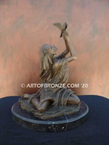 Spirit of the Sky bronze statue of seated Native American Indian woman holding bird