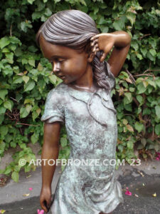 Girls Best Friend bronze sculpture of girl playing with puppy