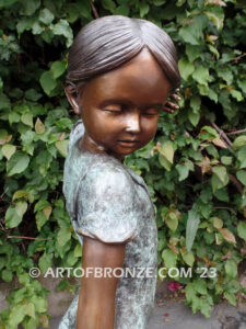 Girls Best Friend bronze sculpture of girl playing with puppy