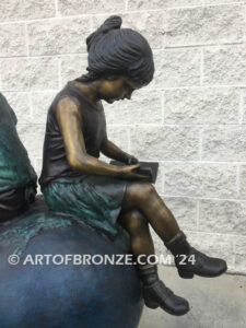 Global Scholars bronze sculpture of boy and girl sitting on globe reading book