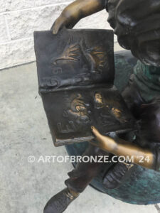 Global Scholars bronze sculpture of boy and girl sitting on globe reading book