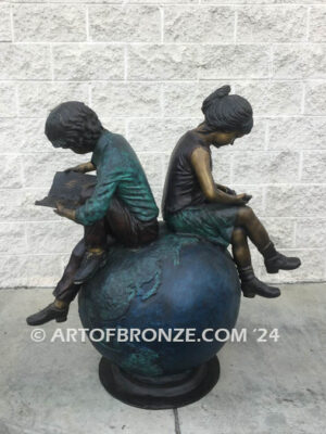 Global Scholars bronze sculpture of boy and girl sitting on globe reading book