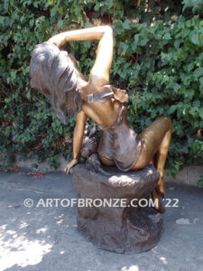 Relaxing Beauty outdoor alluring woman on rock bronze sculpture