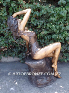 Relaxing Beauty outdoor alluring woman on rock bronze sculpture