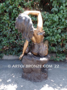 Relaxing Beauty outdoor alluring woman on rock bronze sculpture