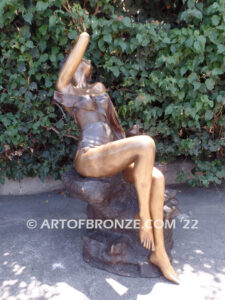 Relaxing Beauty outdoor alluring woman on rock bronze sculpture