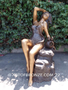 Relaxing Beauty outdoor alluring woman on rock bronze sculpture