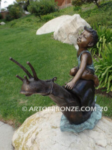 Snail Race outdoor bronze statue of young boy on snail