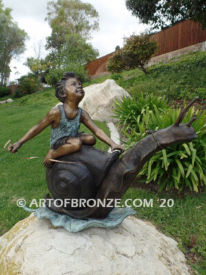 Snail Race outdoor bronze statue of young boy on snail