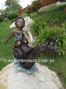 Snail Race outdoor bronze statue of young boy on snail