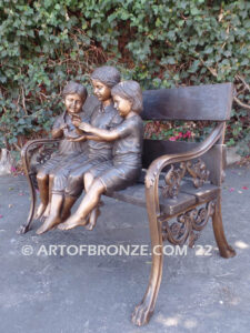 Special Touch bronze sculpture of three kids sitting on log with a injured baby bird in their hands