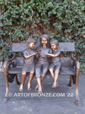 Special Touch bronze sculpture of three kids sitting on log with a injured baby bird in their hands