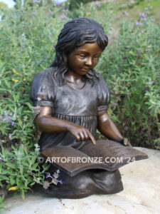 Tales and Dreams bronze statue of young girl reading her favorite novel