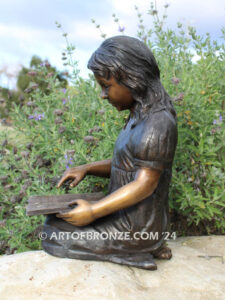 Tales and Dreams bronze statue of young girl reading her favorite novel