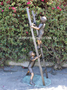 Team work bronze statue children climbing ladder to rescue cat for outdoor display