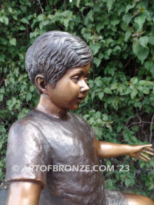 Teeter Totter bronze sculpture of children playing on teeter totter.