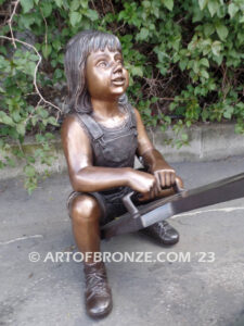 Teeter Totter bronze sculpture of children playing on teeter totter.