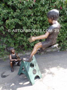 Teeter Totter bronze sculpture of children playing on teeter totter.