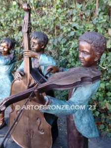 Virtuoso Pals wonderful outdoor bronze sculpture featuring three children playing music concert