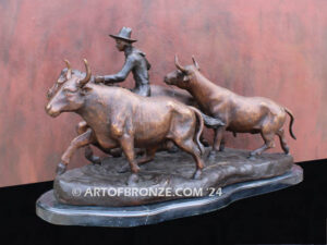 Cattle Herding bronze statue of rancher on horse steering his cattle