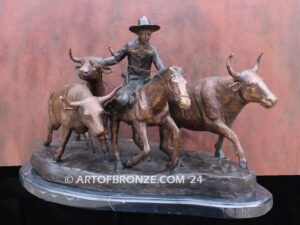 Cattle Herding bronze statue of rancher on horse steering his cattle