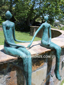 Bond of Us modern bronze sculpture of two sitting figures holding hands