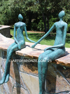 Bond of Us modern bronze sculpture of two sitting figures holding hands