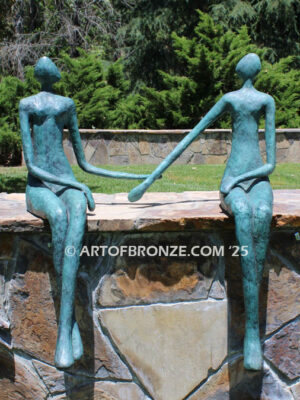 Bond of Us modern bronze sculpture of two sitting figures holding hands