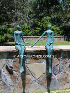 Bond of Us modern bronze sculpture of two sitting figures holding hands