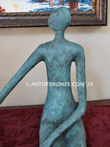 Bond of Us modern bronze sculpture of two sitting figures holding hands