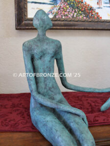 Bond of Us modern bronze sculpture of two sitting figures holding hands