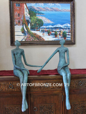 Bond of Us modern bronze sculpture of two sitting figures holding hands