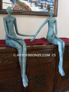 Bond of Us modern bronze sculpture of two sitting figures holding hands