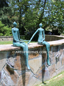 Bond of Us modern bronze sculpture of two sitting figures holding hands