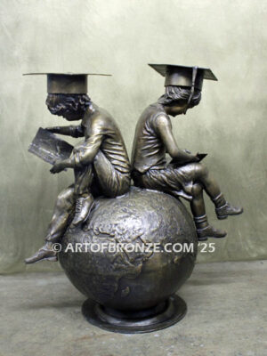 Global Scholars bronze statue of boy and girl sitting on globe reading book