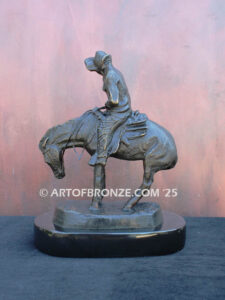 The Norther bronze statue after Frederic Remington featuring cowboy caught in forceful winds atop his horse