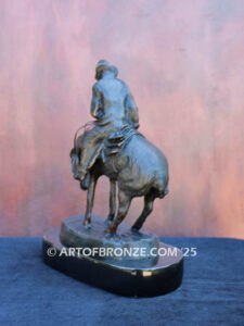 The Norther bronze statue after Frederic Remington featuring cowboy caught in forceful winds atop his horse