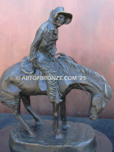 The Norther bronze statue after Frederic Remington featuring cowboy caught in forceful winds atop his horse