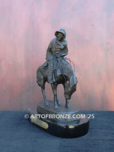 The Norther bronze statue after Frederic Remington featuring cowboy caught in forceful winds atop his horse