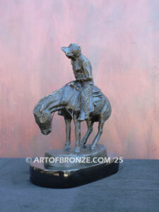 The Norther bronze statue after Frederic Remington featuring cowboy caught in forceful winds atop his horse