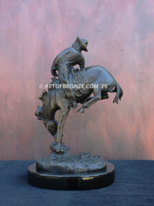 Outlaw bronze statue cowboy on bucking horse after Frederic Remington