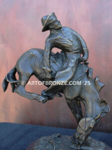 Outlaw bronze statue cowboy on bucking horse after Frederic Remington