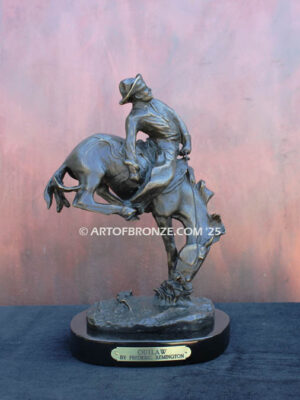 Outlaw bronze statue cowboy on bucking horse after Frederic Remington