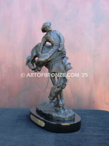 Outlaw bronze statue cowboy on bucking horse after Frederic Remington