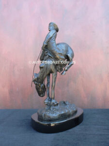 Outlaw bronze statue cowboy on bucking horse after Frederic Remington